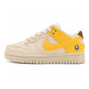 Nike SB beige and yellow shoes