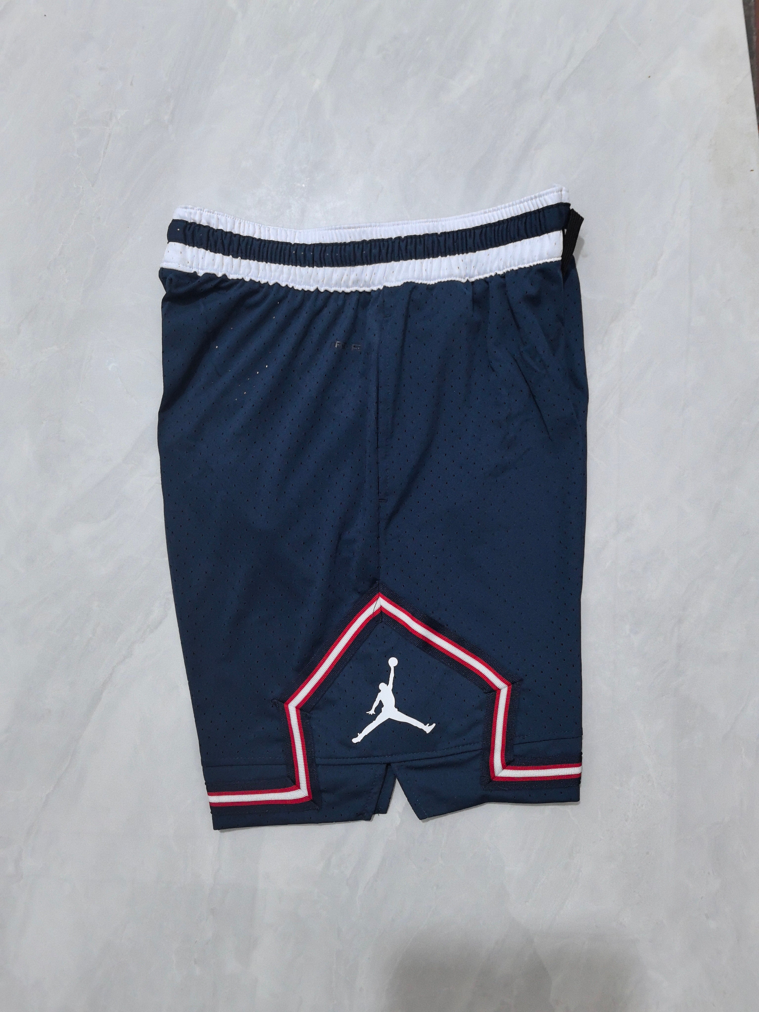 Jordan A-22 blue, white and red striped basketball shorts