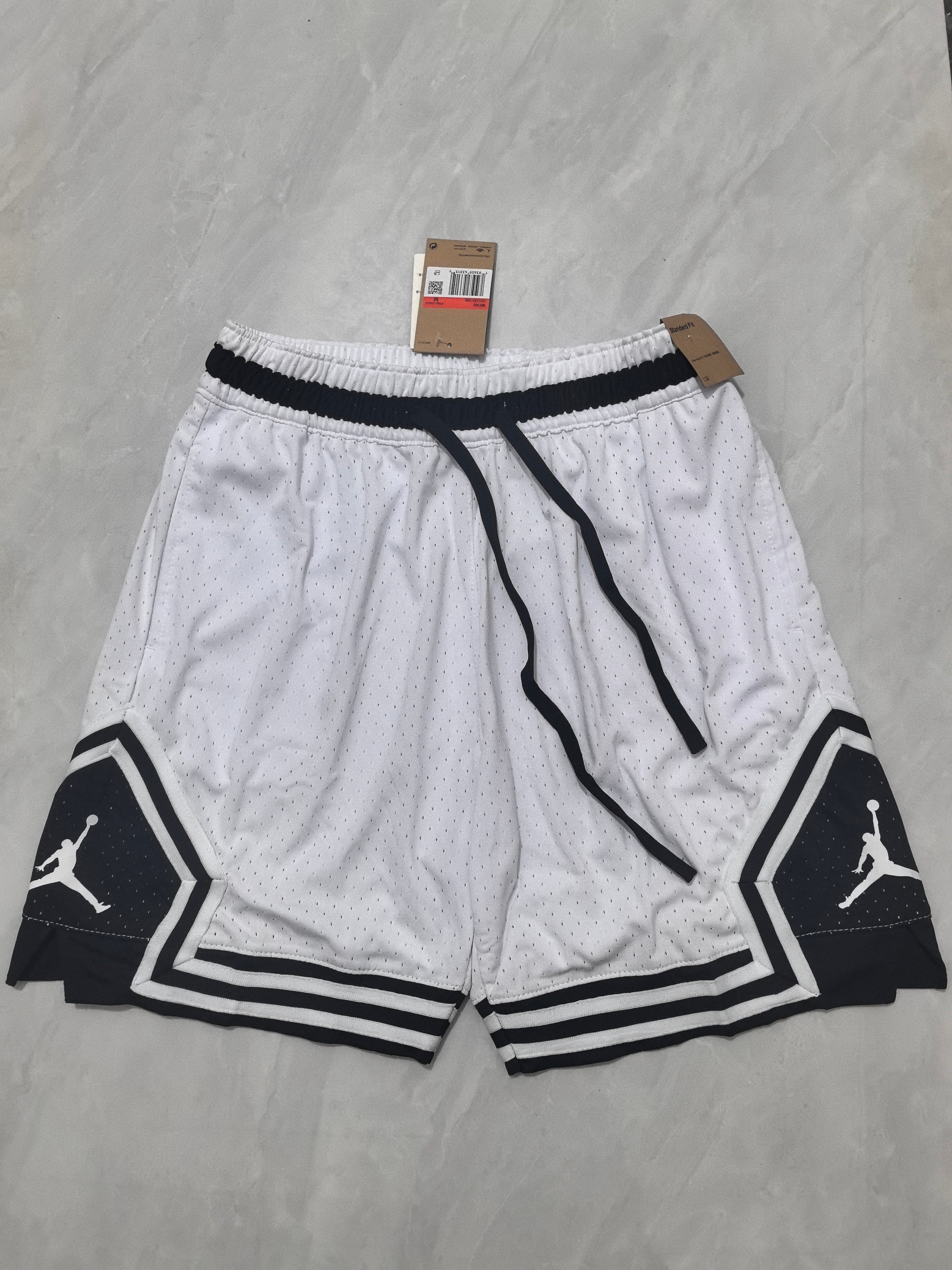 Jordan A-4 white shorts with black cleats